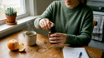 Woman using mushroom supplement at kitchen table